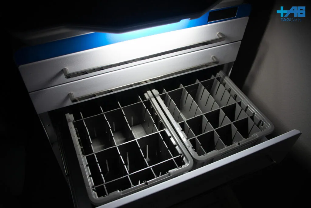 Open stainless steel drawer with metal dividers and compartments for storage and organization