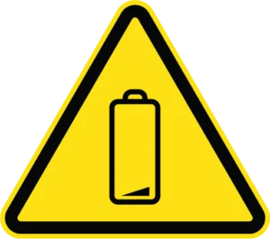 Yellow triangle warning sign with black border containing a battery icon with low charge indicator